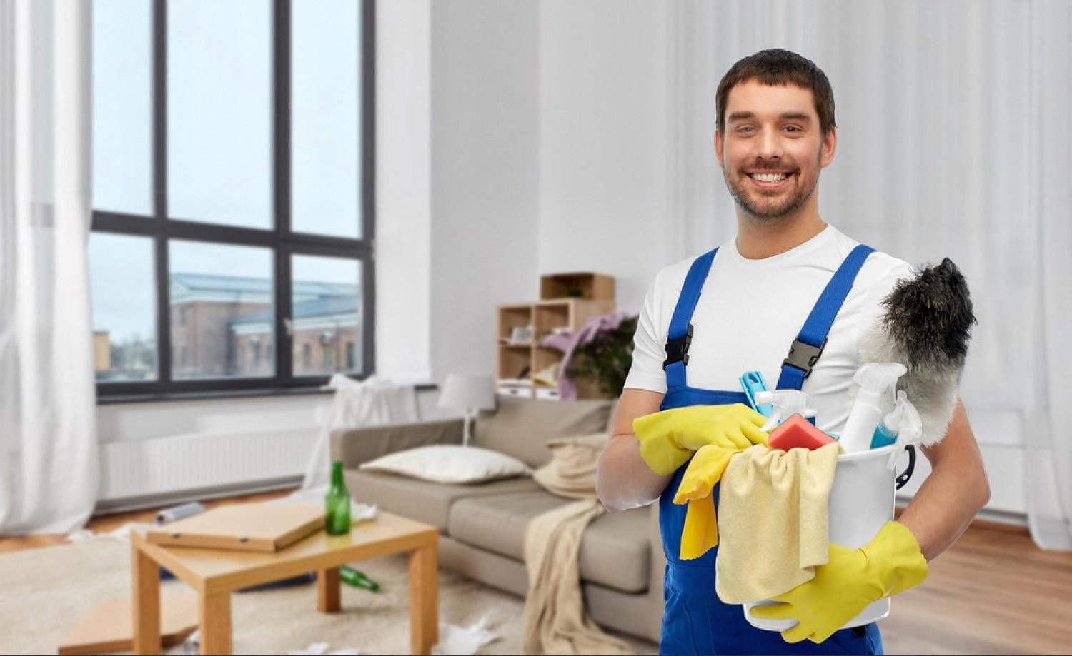 Smiling home maintenance worker with cleaning supplies in a living room